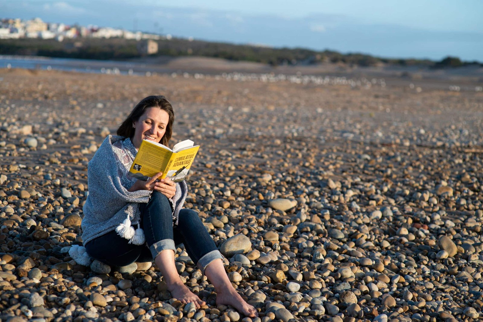 8 Small Things You Can Do to Self-Improve Your Life women reading book at beach to Self-Improve