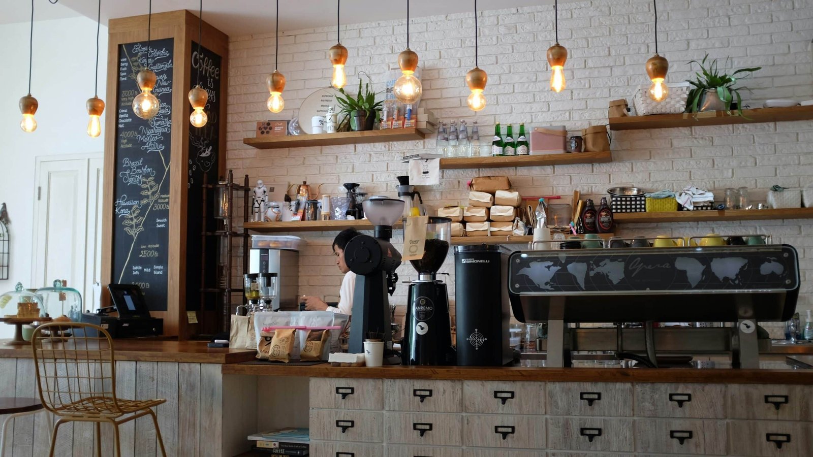 a women brewing coffee behind the counter