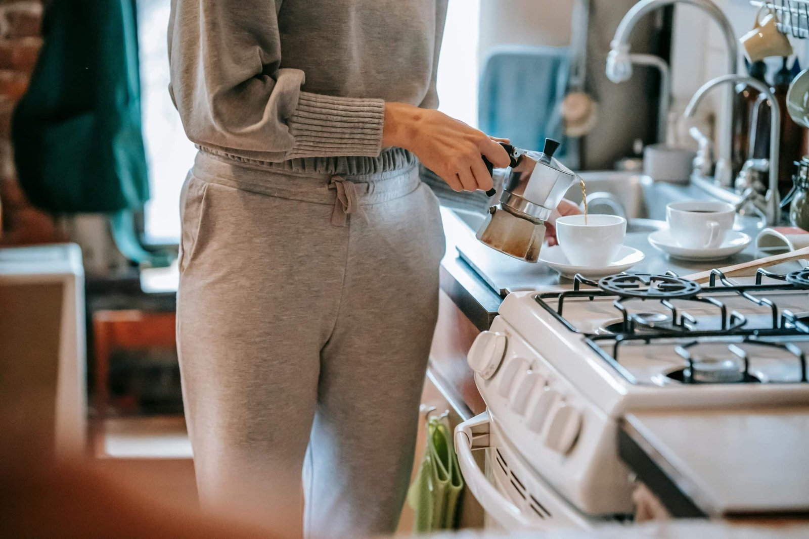a person pouring coffee into a cup