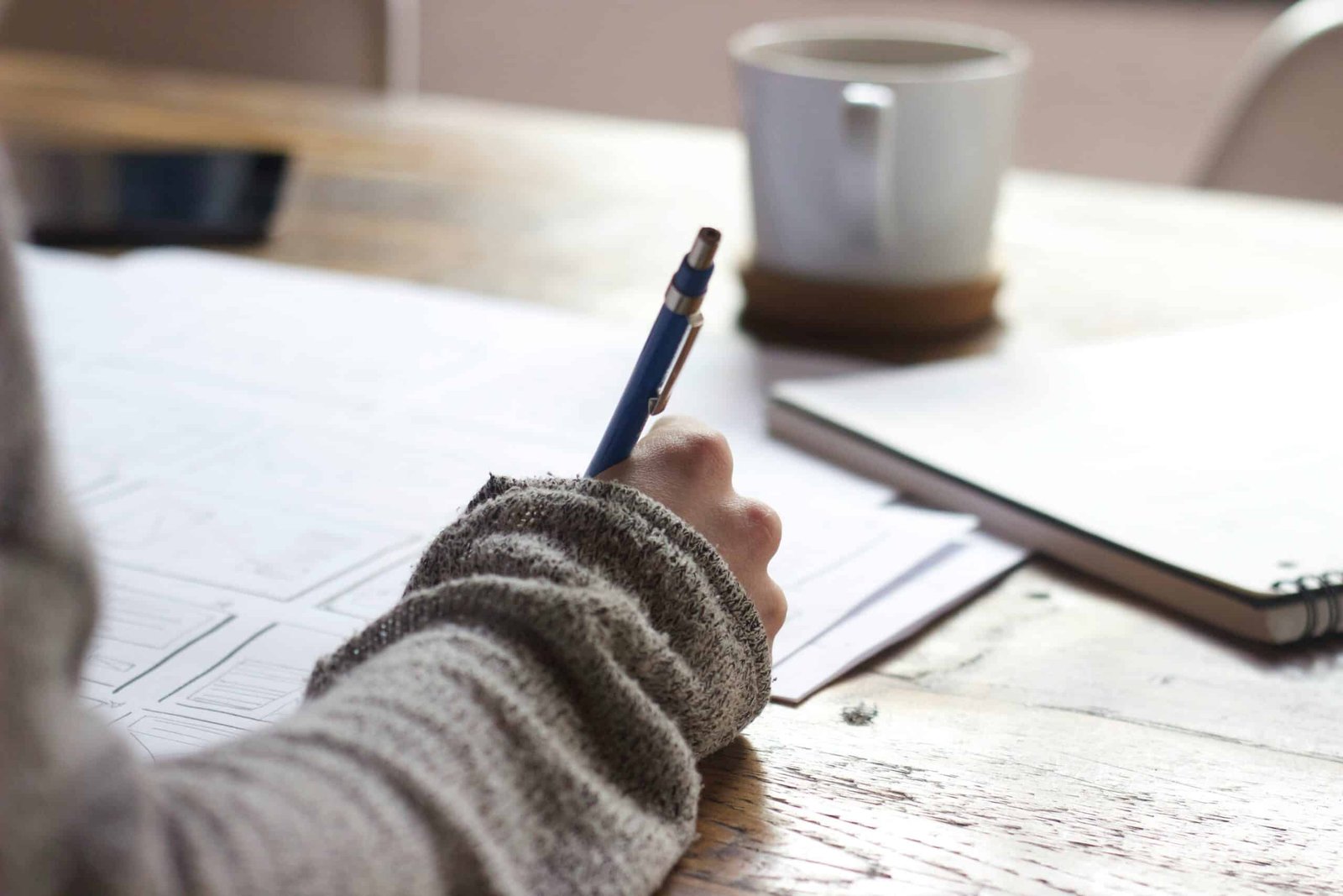 a hand holding a pen