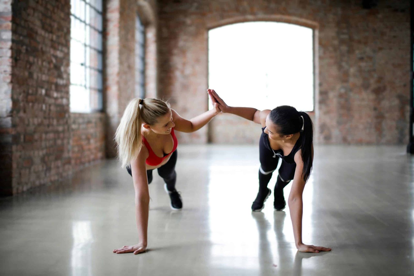 women performing HIIT
