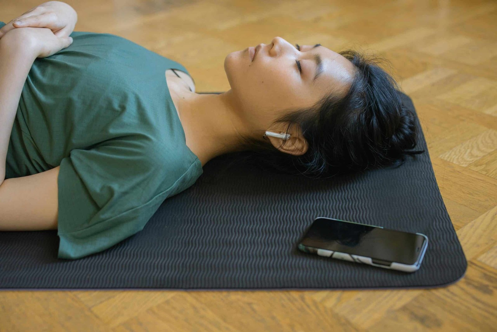 women with AirPod on floor sleeping